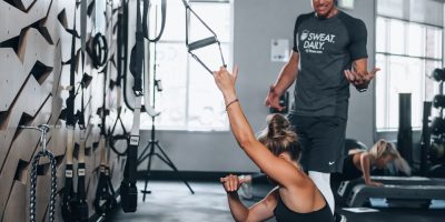 woman in black tank top and black leggings doing yoga